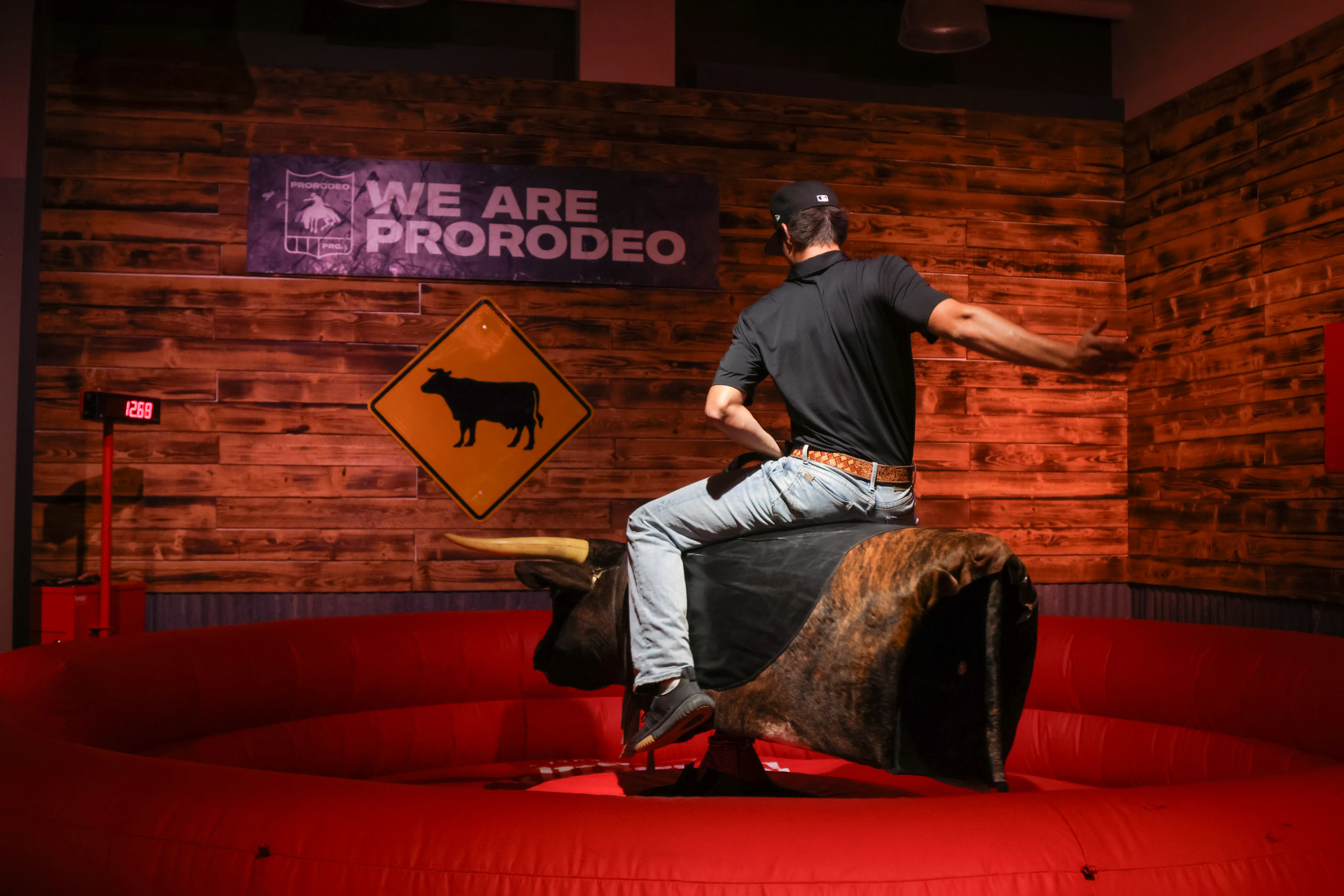 Rider on mechanical bull at a Utah corporate team-building event