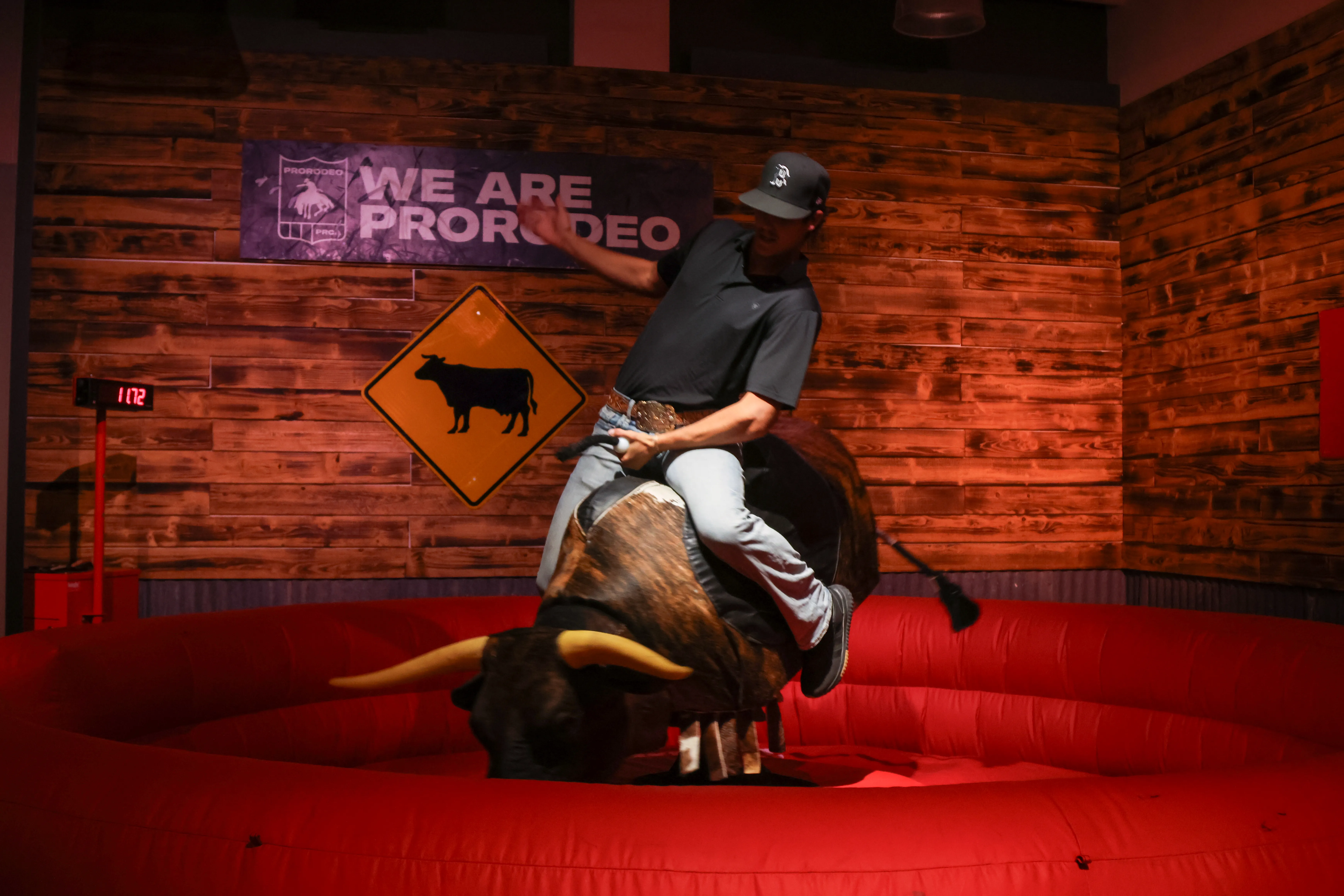 Rider on mechanical bull at a Utah indoor wedding reception event